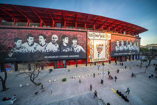 people walk around Sevilla FCs iconic Ramon Sanchez-Pizjuan Stadium in Nervion, Seville, Spain.