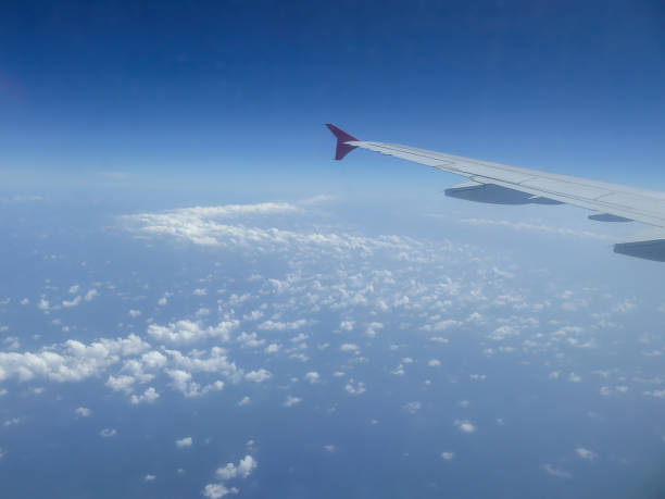 istock View from airplane window on plane wing and sky with clouds 2149242509