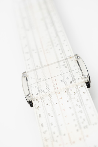 old slide rule slipstick analogue computer for mathematical calcululs, on a white screen background