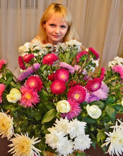 istock Young woman with a beautiful bouquet of flowers. 2149242584