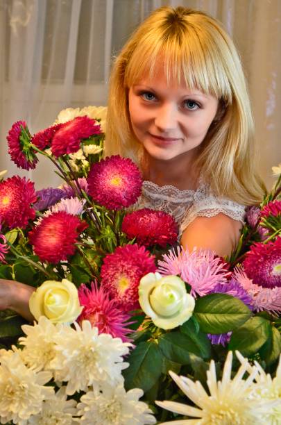 Young woman with a beautiful bouquet of flowers.