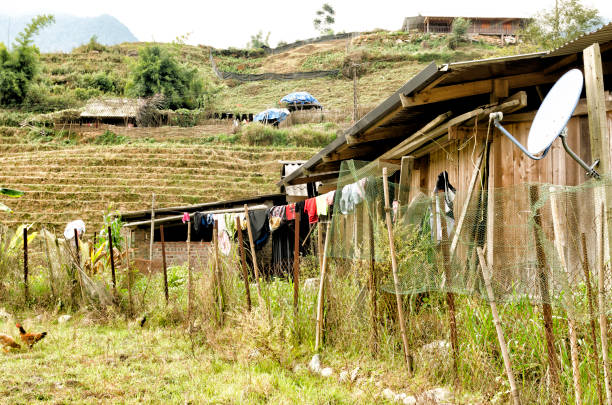The photograph was taken on November 19, 2023 in Sapa (Vietnam). In any place in the center of the rice fields, houses are located as a common home in which to carry out the usual household tasks. A parabolic antenna cannot be missing to maintain contact with the outside.