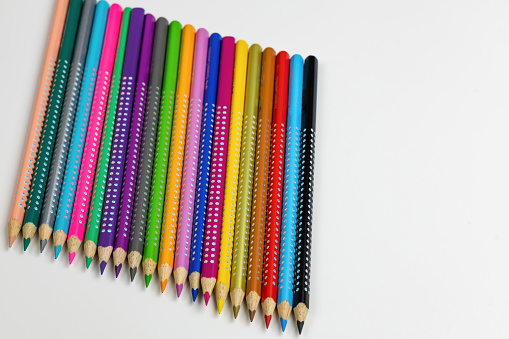 Colored pencils for drawing various colors and coloring book for children. Children's creativity concept.