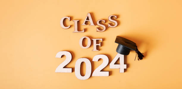 istock Class of 2024 concept. Number 2024 with graduated cap on orange banner background 2149245791