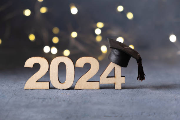 istock Class of 2024 concept. Number 2024 with graduated cap and bokeh lights. 2149245807
