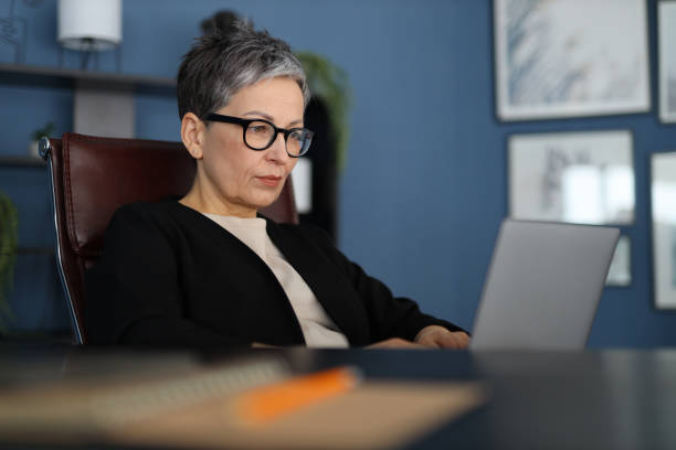 istock A professional businesswoman, confident and attractive, works on her computer in a modern office setting. 2149247426