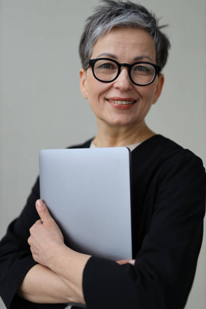 istock A professional executive woman, adept with technology, enjoys a successful career, exuding confidence and happiness. 2149247583