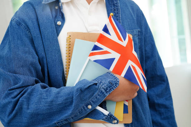 istock Learning English, Asian teenage student holding book with flag for language program education. 2149247624