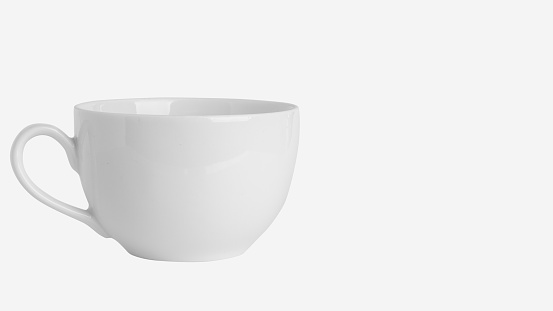 White cup, mug on a light  with empty spacebackground
