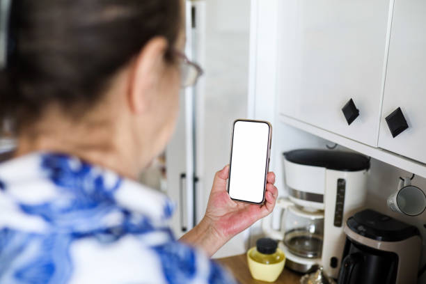 istock Old Woman Looking at White Blank Phone Screen, Retirement Life, Technology And People, Mobile App, Social Media Use 2149249475