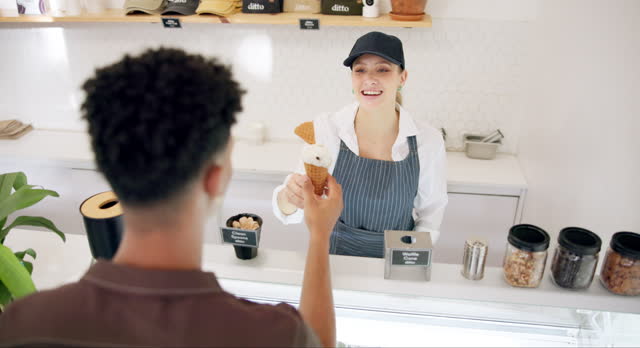 Customer, ice cream and shop seller with dessert or frozen food with happy cashier at counter. Woman, man and giving gelato cone, sweets and dairy sugar for service of employee with smile at store