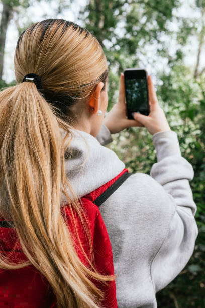 istock Hiker taking photos in a leafy forest 2149251126