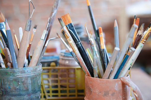 Different brushes in drawing studio interior. Close up view