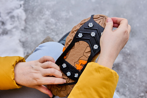 8 studs anti-slip safety rubber shoe grip pad is installed on hiking boots.