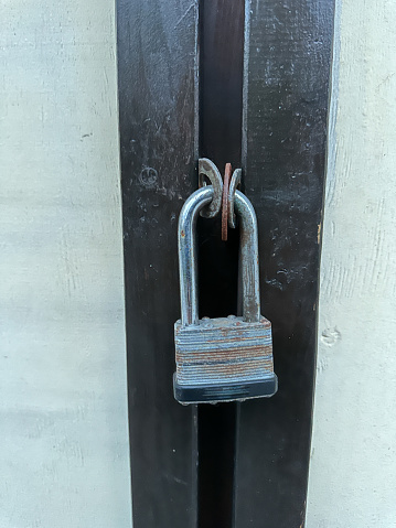 Old lock on the door. Background texture: a closed door with a lock. Closed entrance to the premises.