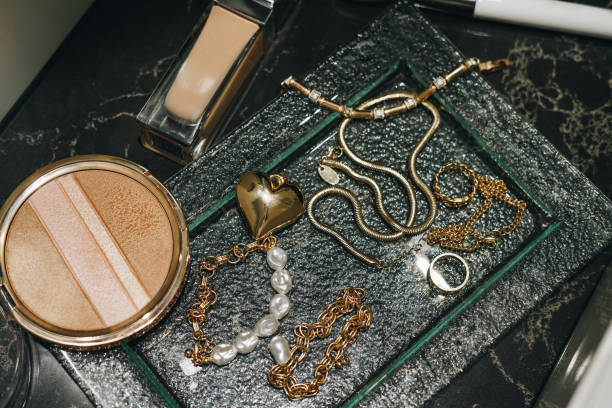 istock Luxury make-up  and gold jewelry on dark marble background 2149255697