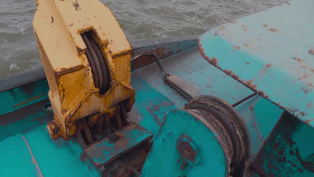 The process of lifting the anchor using a windlass. stock video