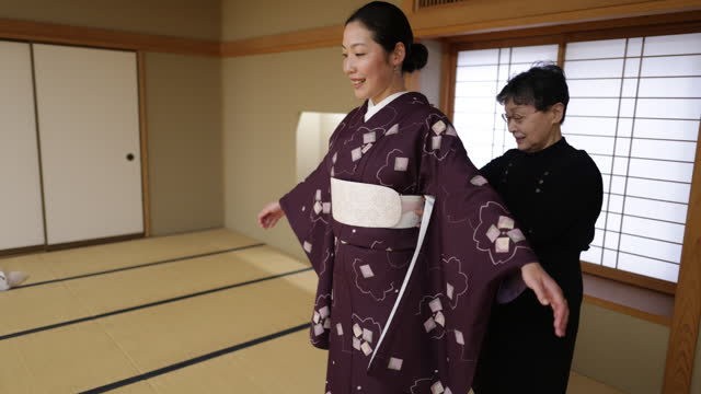 Female tourists getting kimono dressed in Japanese tatami room - part 2 of 2