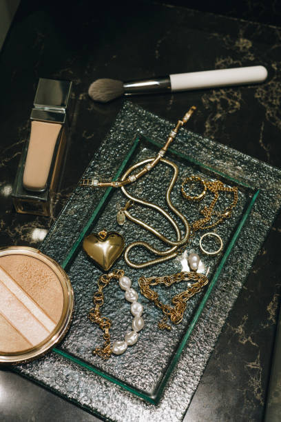 istock Luxury make-up  and gold jewelry on dark marble background 2149256441
