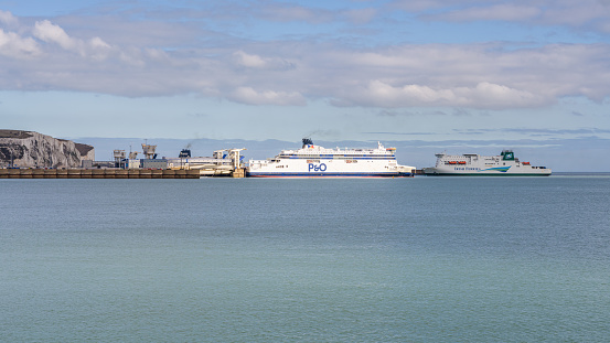 Dover, Kent, England, UK - March 19, 2023: View of a ferry waiting in the harbor and another ferry arriving