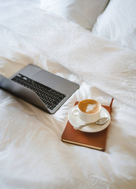 istock Laptop and cappuccino on the bed, work from home concept 2149261542