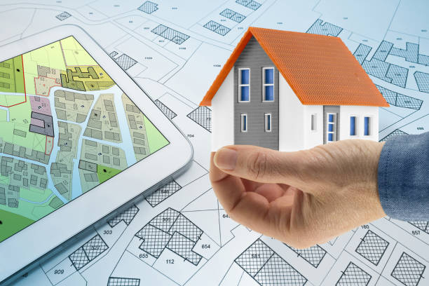 istock Buildings Permit concept with digital tablet, imaginary cadastral and residential building project - Building activity and construction industry with General Urban Plan and home model 2149266251