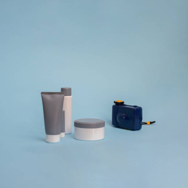 istock Creative summer objects concept. Toy camera and cosmetics products on a blue background. 2149266590