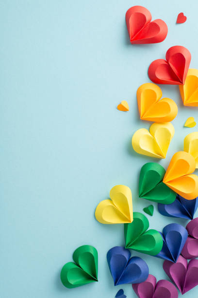 istock Love knows no bounds: Vertical top view of colorful hearts on pastel blue, symbolizing unity. Ideal for expressing support during Pride month. Space for impactful social messages or adverts 2149267221