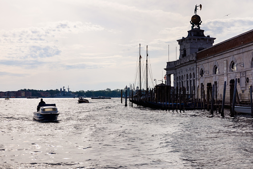 Boats going through the main canal in Venice, Italy. Here boats are the main mode of transport.