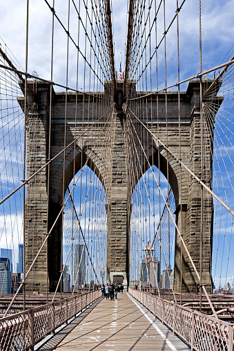 View of the Brooklyn Bridge, in the centre of New York, USA,  People can be seen walking over the bridge