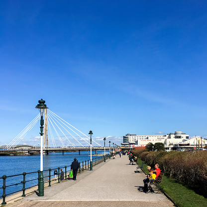 View along Southport's promenade, UK  Marine lake can be seen on the left of the photograph and people can be seen on the promenade.