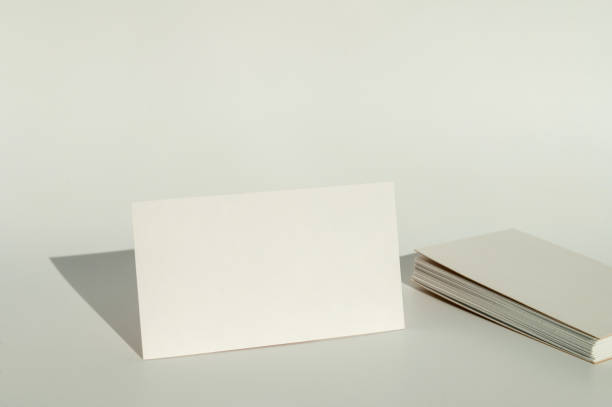 istock White blank business card on brown paper background with soft shadow. 2149270320