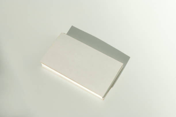 istock White blank business card on brown paper background with soft shadow. 2149270322