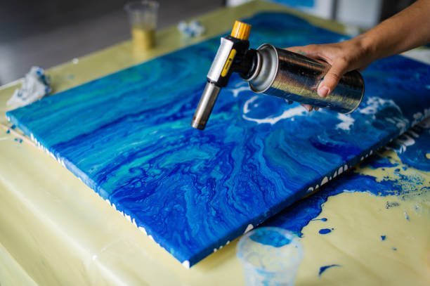 Artist Applying Heat to Epoxy Resin Art