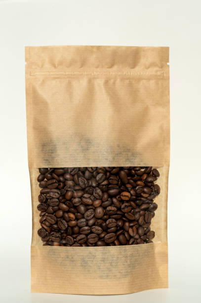 istock A kraft paper bag with coffee beans for viewing with a highlighted shadow lies on a white background 2149270350