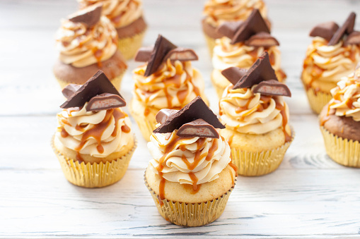 Homemade butterscotch cupcakes with caramel syrup and cream cheese frosting