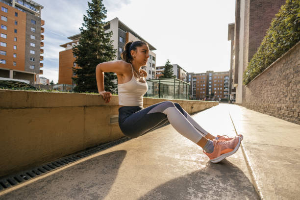 istock Young woman stretching and warming up before training outdoors 2149271538
