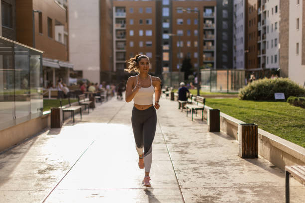 Young woman running and warming up before training outdoors