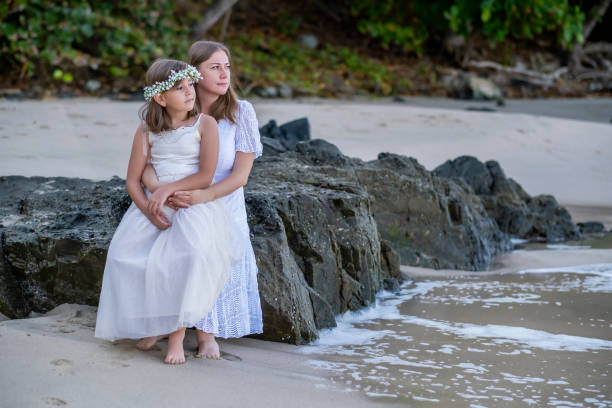 istock Mom and daughter at the beach 2149273054