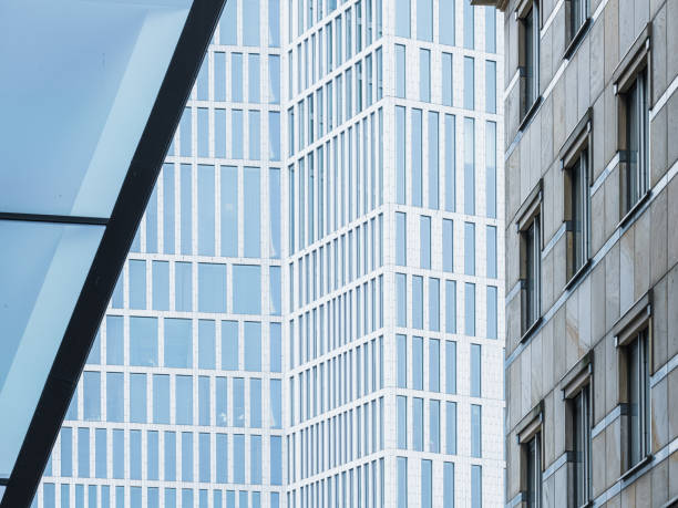 A tall building with numerous windows stands next to another building in Malmo, Sweden. The buildings create a striking urban skyline, showcasing modern architecture and dense city living.