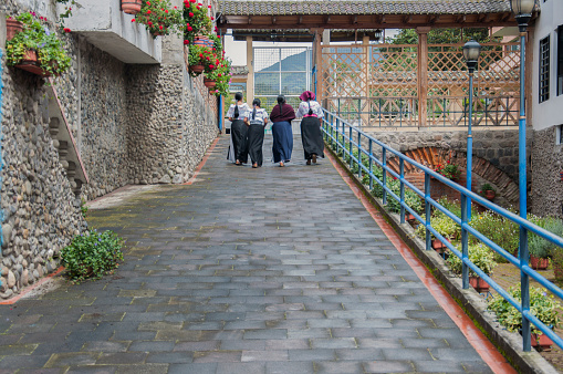 A group of indigenous women from Ecuador enjoy a quiet walk through the center of the city of Otavalo