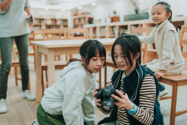 istock Two girls are looking at a camera. 2149276934