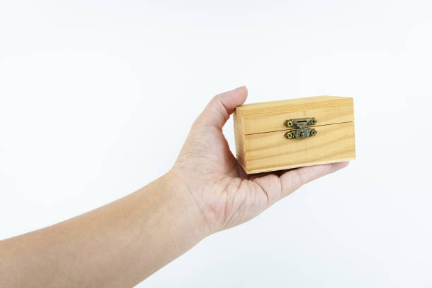 istock hand holding small wooden box on white background. 2149277077