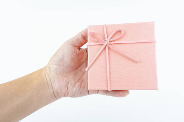 istock Hand holding pink gift box on white background. 2149277078
