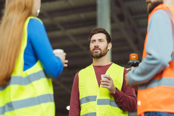 istock Handsome, attractive, bearded man, worker, engineer talking to employee while standing in warehouse 2149277403