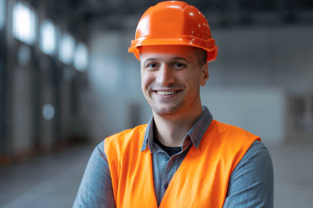 istock Closeup handsome, smiling man, architect, wearing hard hat, looking at camera, standing in warehouse 2149277410