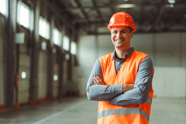 istock Happy, professional man, foreman, builder wearing hard hat, looking at camera with crossed arms 2149277412