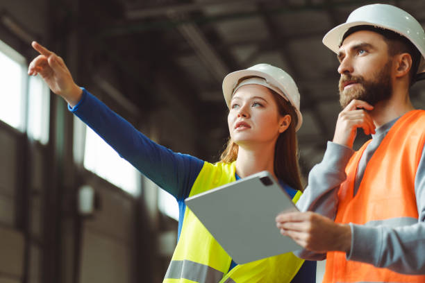 istock Successful, retired woman working with her foreman, gesturing while standing in a warehouse 2149277439