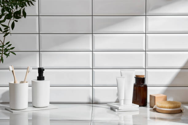 istock Marble shelf in the bathroom with various objects against a background of white tiles 2149280295