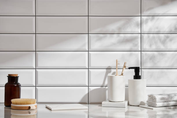 istock Marble shelf in the bathroom with various objects against a background of white tiles 2149280303
